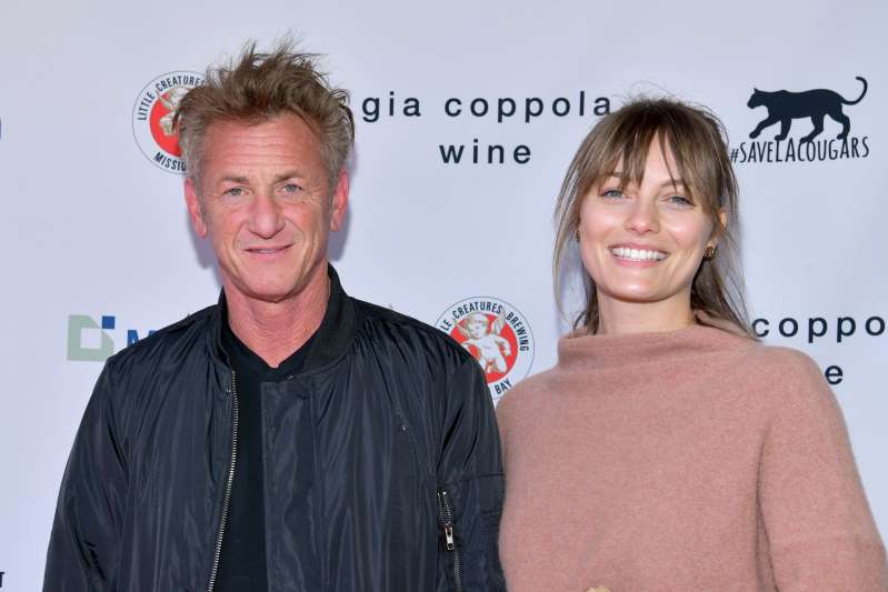 Sean Penn et al. posing for the camera: Sean Penn and Leila George