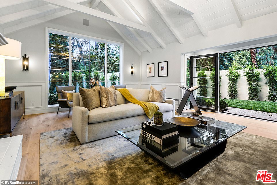 Vaulted: One more informal area featured vaulted ceilings with white walls and white painted wood beams