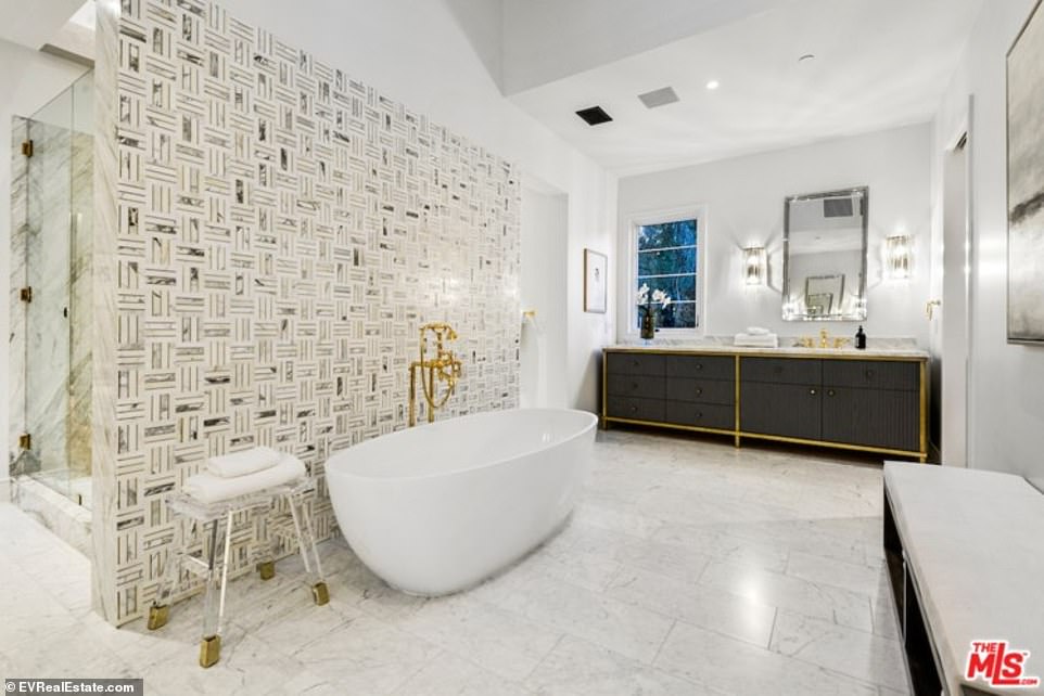 Luxurious: Two walkways lead from the sleeping area into the luxurious bathroom, with his and hers everything