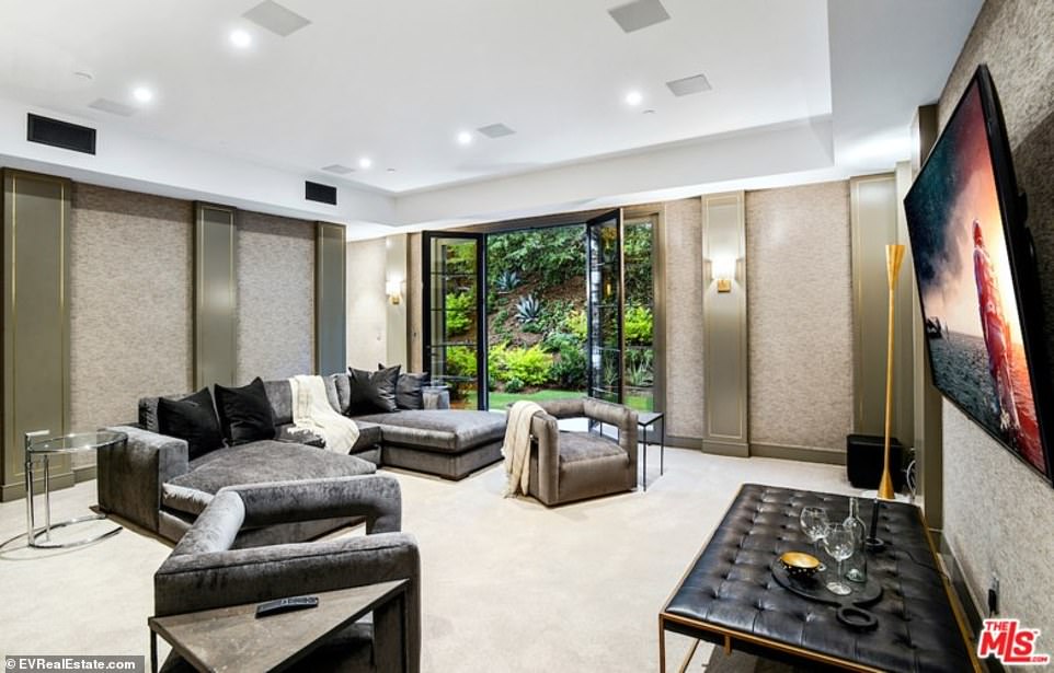 Home viewing: A theater room, that could double as an eighth bedroom, is just beside the laundry room, with a full sized closet and bathroom, and is set-up for TV viewing with padded walls and a dark design